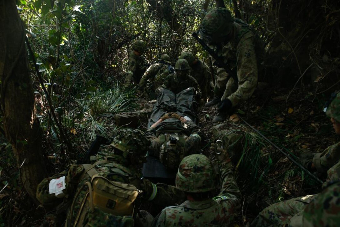 U.S. Marines with 1st Battalion, 2d Marines and members of the Japan Self-Defense Force Amphibious Rapid Deployment Brigade practice combat lifesaving training during Keen Sword 23 at Tsutara, Japan, Nov. 16, 2022. Keen Sword is a biennial training event that exercises the combined capabilities and lethality developed between 3d Marine Division, III Marine Expeditionary Force, and the Japan Self-Defense Force. This bilateral field-training exercise between the U.S. military and JSDF strengthens interoperability and combat readiness of the U.S.-Japan Alliance. (U.S. Marine Corps photo by Cpl. Scott Aubuchon)