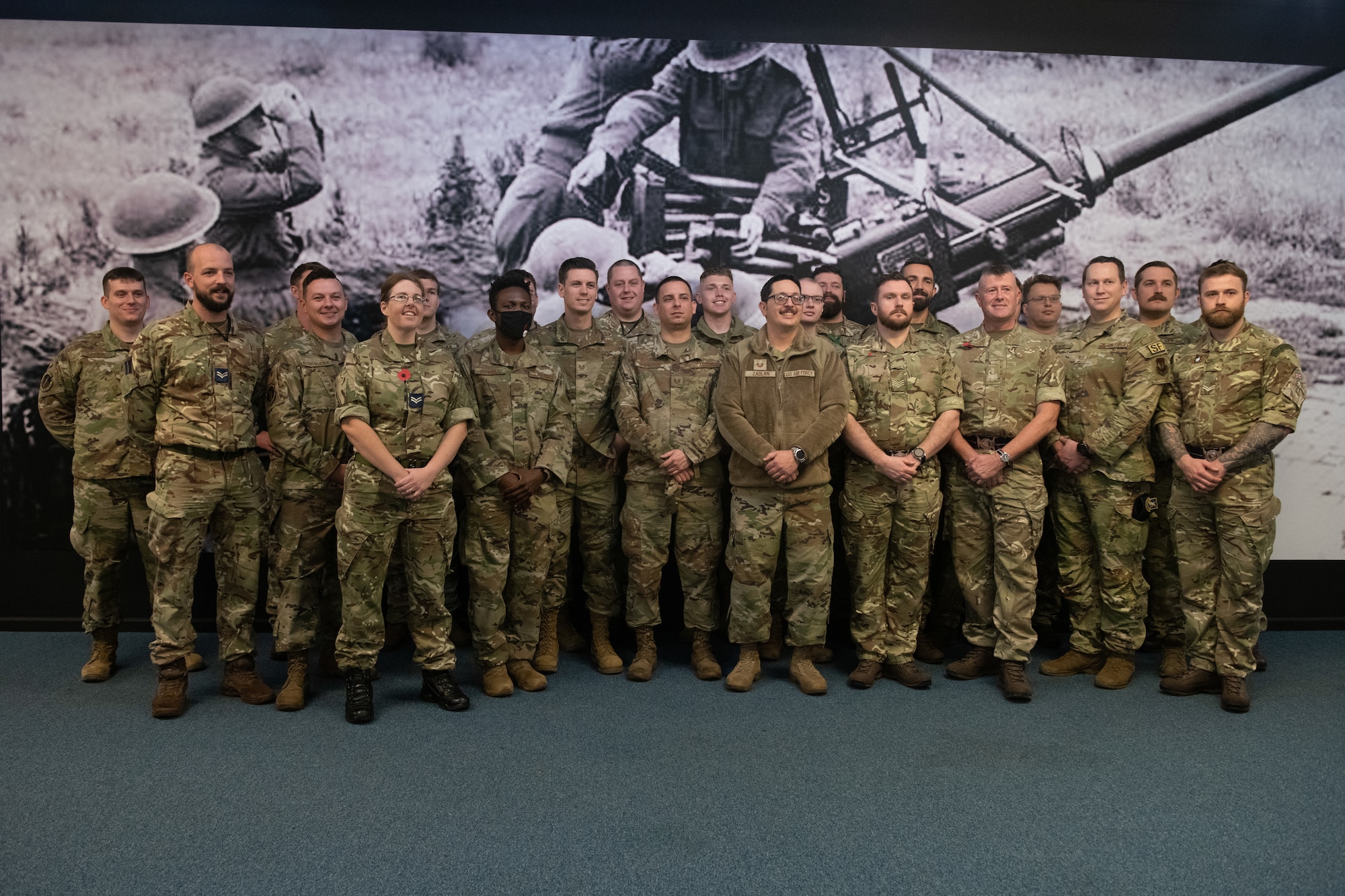 U.S and Royal Air Force personnel pose for a photo in the heritage hall on RAF Honington, England, Nov. 10, 2022. RAF Honington hosted U.S. Air Force noncommissioned officers for a leadership exchange program, strengthening ties between partner nations. (U.S. Air Force photo by Staff Sgt. Charles Welty)