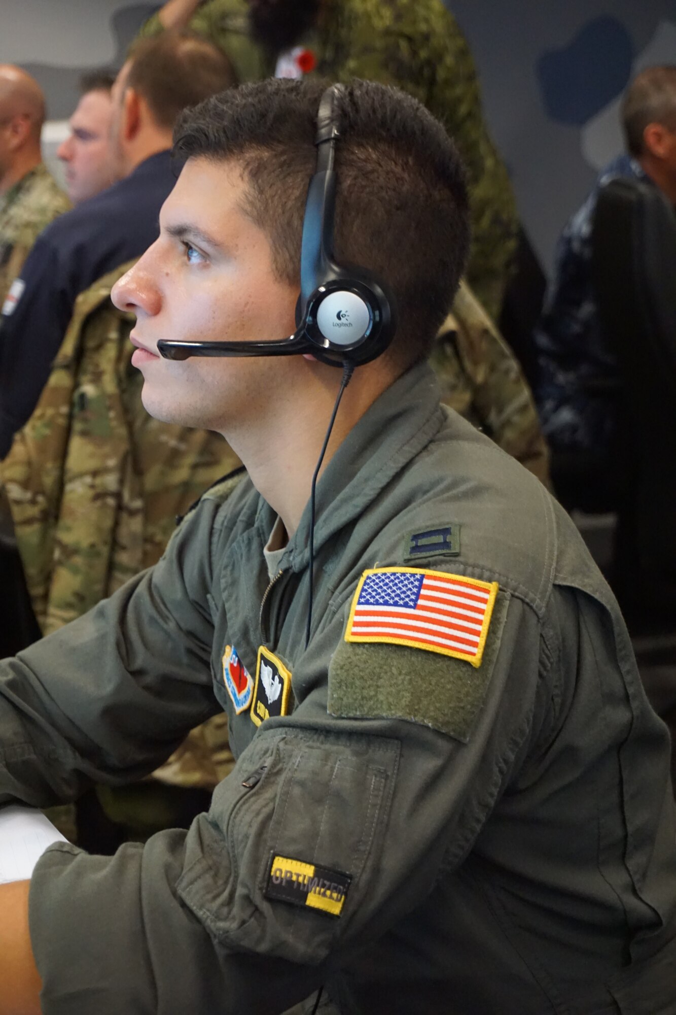 military member sits at computer working