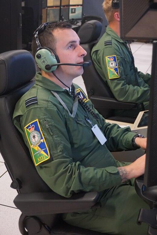 military members flying simulators