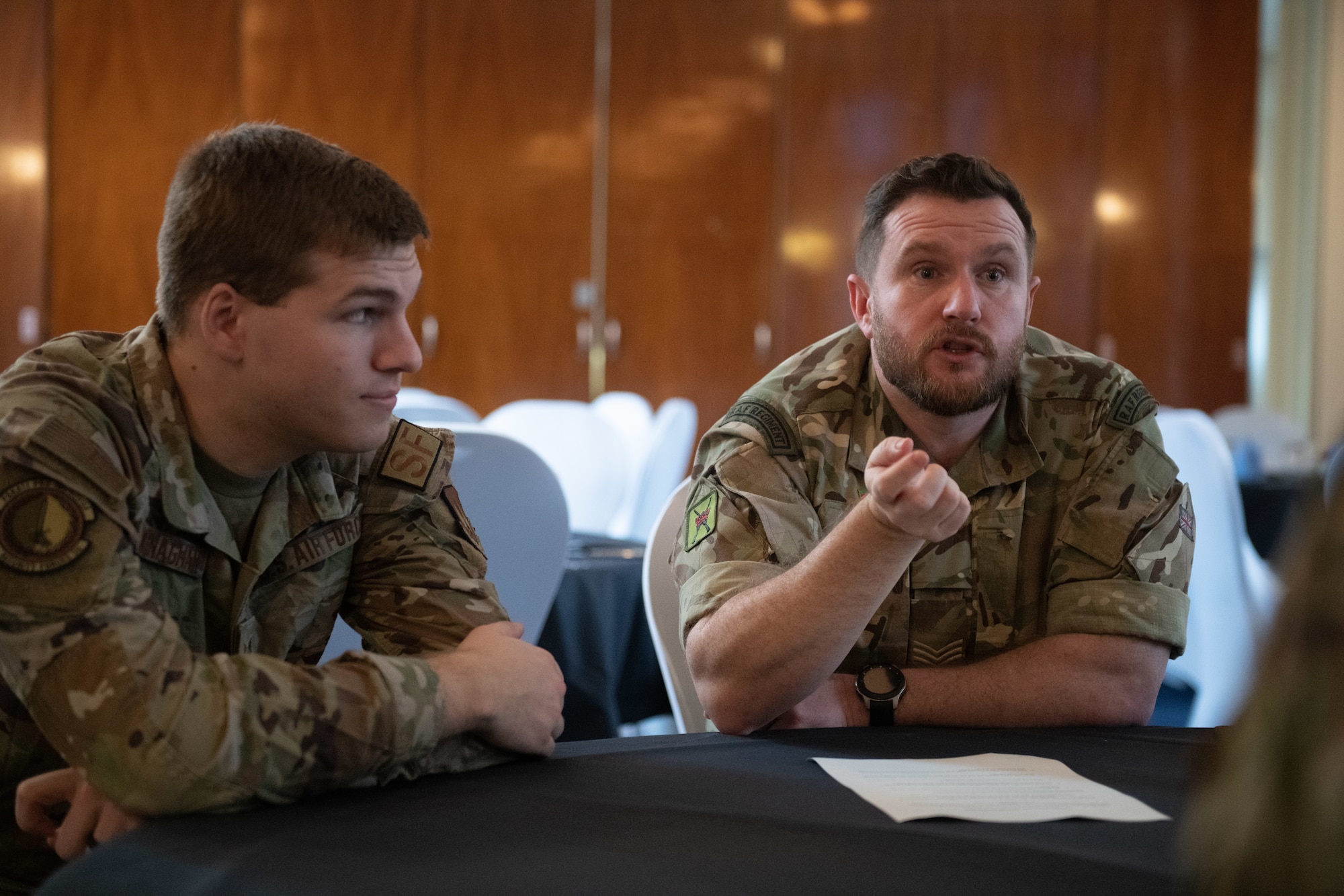 U.S. and Royal Air Force personnel talk during a leadership collaboration event Nov. 10, 2022, at RAF Honington, England. The goal of the event was to give noncommissioned officers from both nations the opportunity to share knowledge and experiences as well as strengthening bonds between the partner nations. (U.S. Air Force photo by Staff Sgt. Charles Welty)