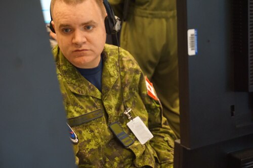 military member working at computer