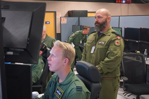 military members working at simulators