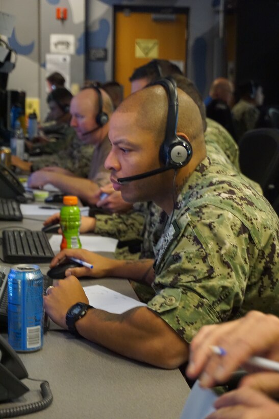 U.S. Navy Sailors participate in VIRTUAL FLAG: Coalition 23-1 at the 705th Combat Training Squadron, also known as the Distributed Mission Operations Center, at Kirtland Air Force Base, New Mexico, and distributed sites across four countries, Oct. 24 – Nov. 4, 2022. Exercise VFC serves as a train as you fight exercise by integrating the full spectrum of air, land, surface, space, and cyber warfighters in a virtual battlespace in joint and coalition environments; forces from the United States, United Kingdom, Australia, and Canada participated. (Documents were blurred for security reasons) (U.S. Air Force photo by Ms. Deb Henley)