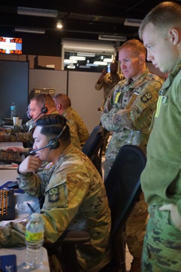 U.S. and coalition forces participate in VIRTUAL FLAG: Coalition 23-1 at the 705th Combat Training Squadron, also known as the Distributed Mission Operations Center, at Kirtland Air Force Base, New Mexico, and distributed sites across four countries, Oct. 24 – Nov. 4, 2022. Exercise VFC serves as a train as you fight exercise by integrating the full spectrum of air, land, surface, space, and cyber warfighters in a virtual battlespace in joint and coalition environments; forces from the United States, United Kingdom, Australia, and Canada participated. (Security badge and computer screens were blurred for security reasons) (U.S. Air Force photo by Ms. Deb Henley)