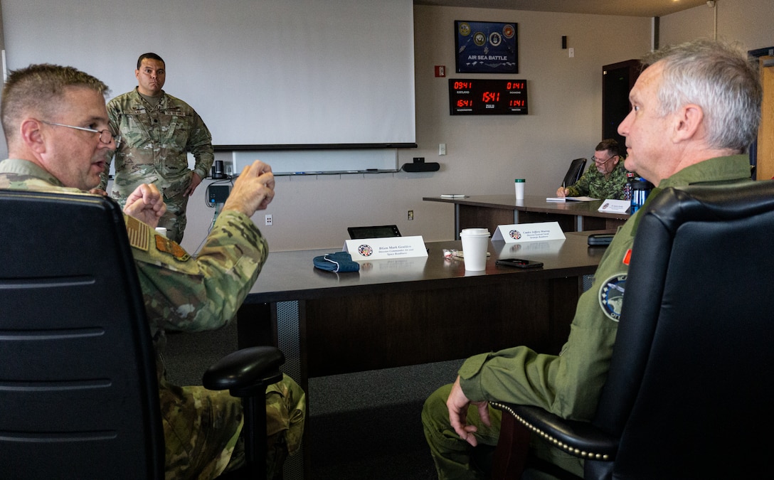 U.S. Air Force Lt. Col. Michael Butler, 705th Combat Training Squadron commander, briefs coalition and U.S. forces VIRTUAL FLAG: Coalition 23-1  distinguished visitors at the Distributed Mission Operations Center, at Kirtland Air Force Base, New Mexico, Oct. 28, 2022. Exercise VFC serves as a train as you fight exercise by integrating the full spectrum of air, land, surface, space, and cyber warfighters in a virtual battlespace in joint and coalition environments; forces from the United States, United Kingdom, Australia, and Canada participated. (Security badges were blurred for security purposes) (U.S. Air Force photo by Ms. Deb Henley)