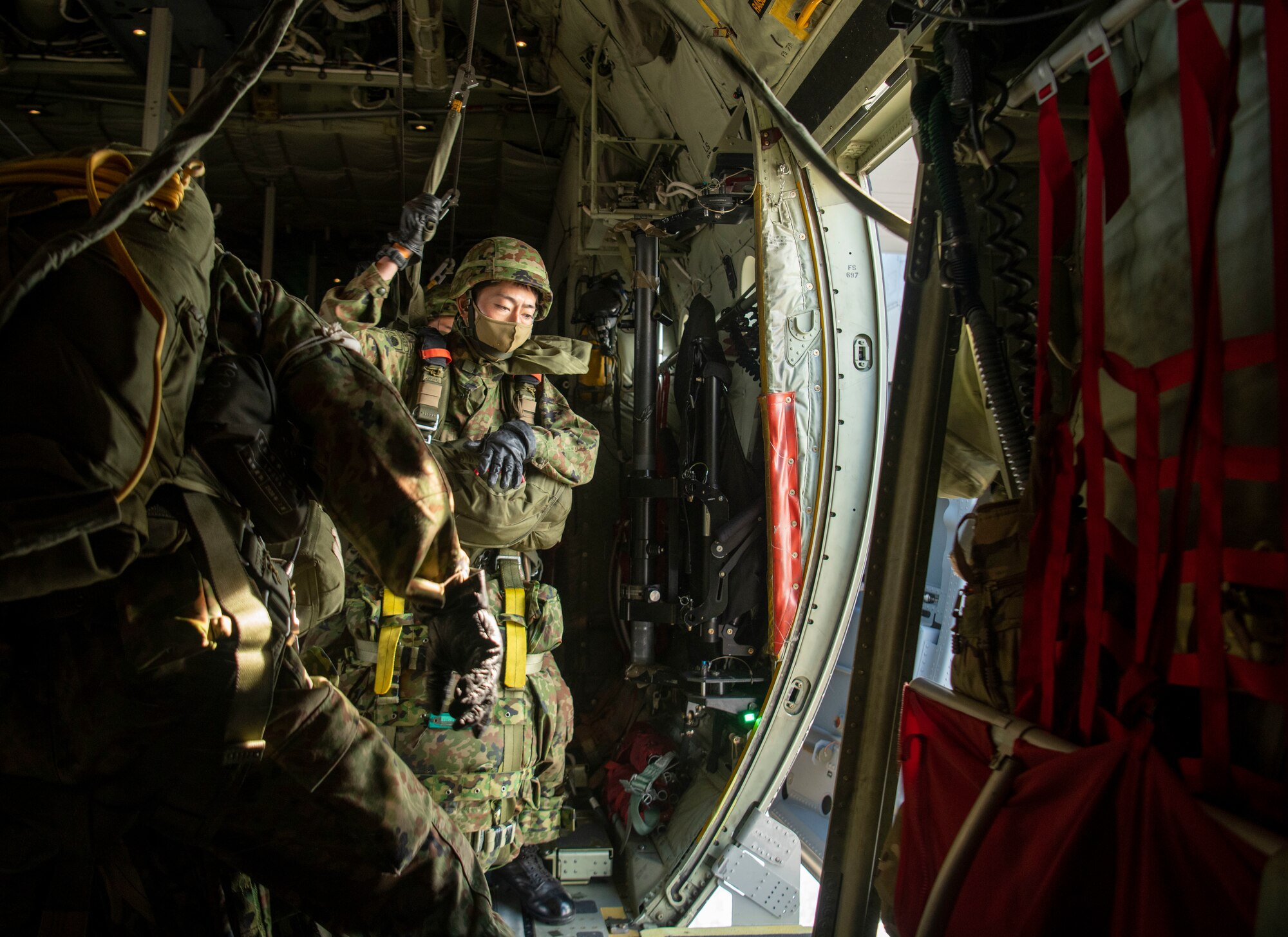 Japan Ground Self-Defense Force paratroopers assigned to the 1st Airborne Brigade jump out of a 36th Airlift Squadron C-130J Hercules over Narashino drop zone, Chiba, Japan