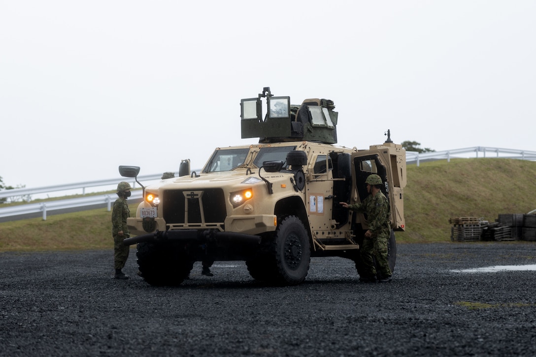 U.S. Marines with 3d Transportation Battalion, Combat Logistics Regiment 3, 3rd Marine Logistics Group, conduct refueling and vehicle demonstrations with Japan Ground Self-Defense Force members during Keen Sword 23 on Amami, Japan, Nov. 12, 2022. Keen Sword is a biennial training event that exercises the combined capabilities and lethality developed between 3rd MLG, III Marine Expeditionary Force and the Japan Self-Defense Force. This bilateral field-training exercise between the U.S. military and JSDF strengthens interoperability and combat readiness of the U.S.-Japan Alliance. (U.S. Marine Corps photo by Sgt. Levi J. Guerra)