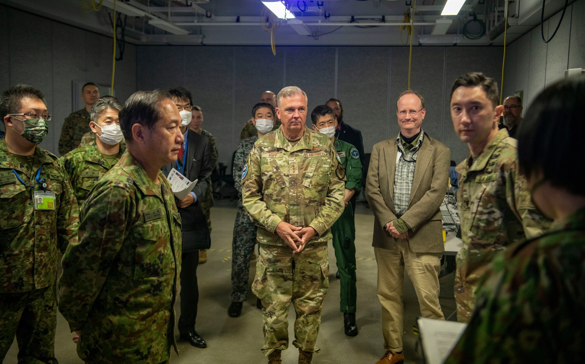 U.S. Air Force Lt. Gen. Ricky Rupp, commander of United States Forces Japan and Fifth Air Force,, and GEN Yamazaki Koji, chief of staff for the Japan Joint Staff, receive a briefing from U.S. Army Pacific and U.S. Army Japan soldiers on cybersecurity readiness during exercise Keen Sword 23 at Sagami Depot, Japan, Nov. 15, 2022.