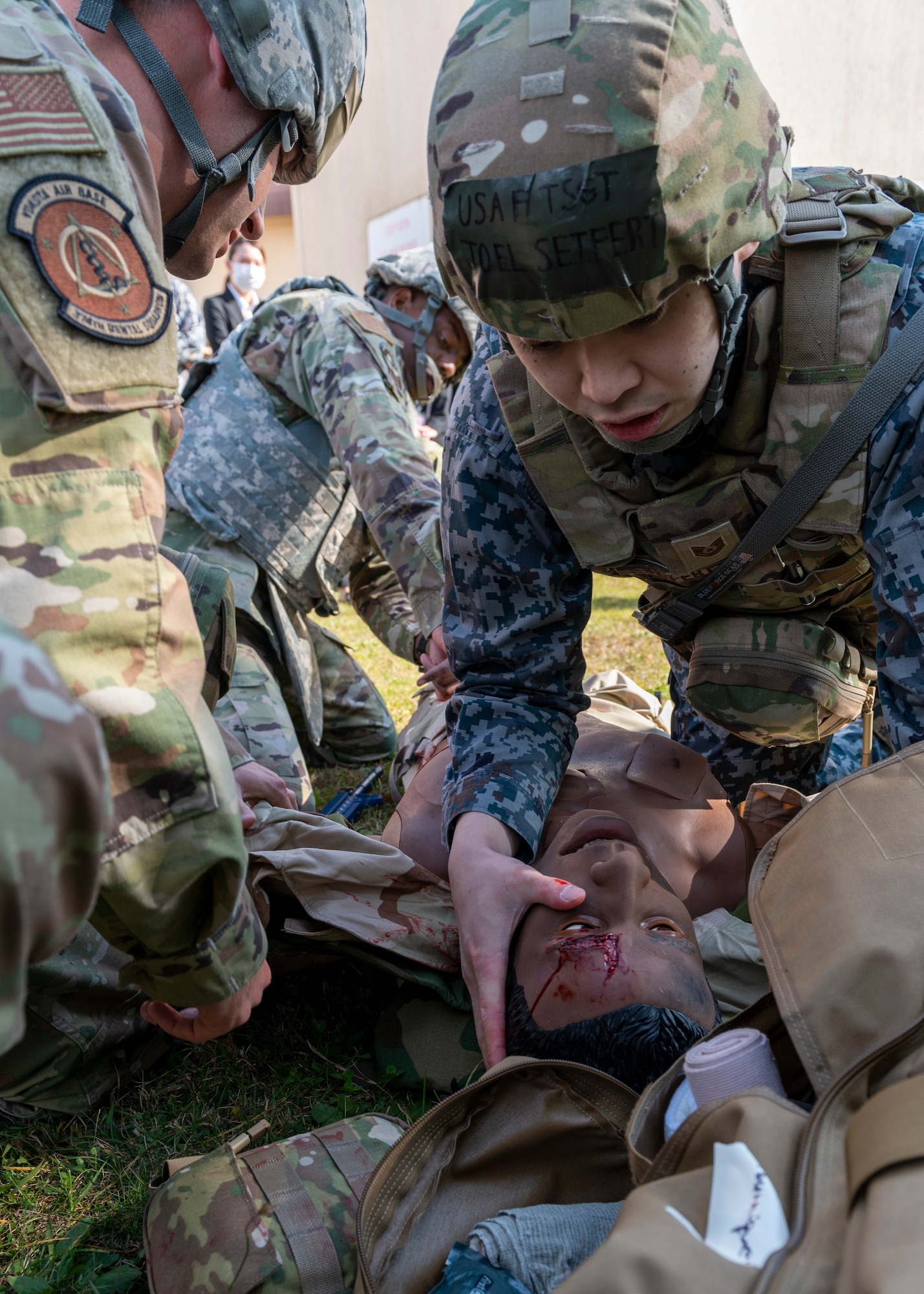 A Japanese medic Airman checks the vitals of a medical training dummy