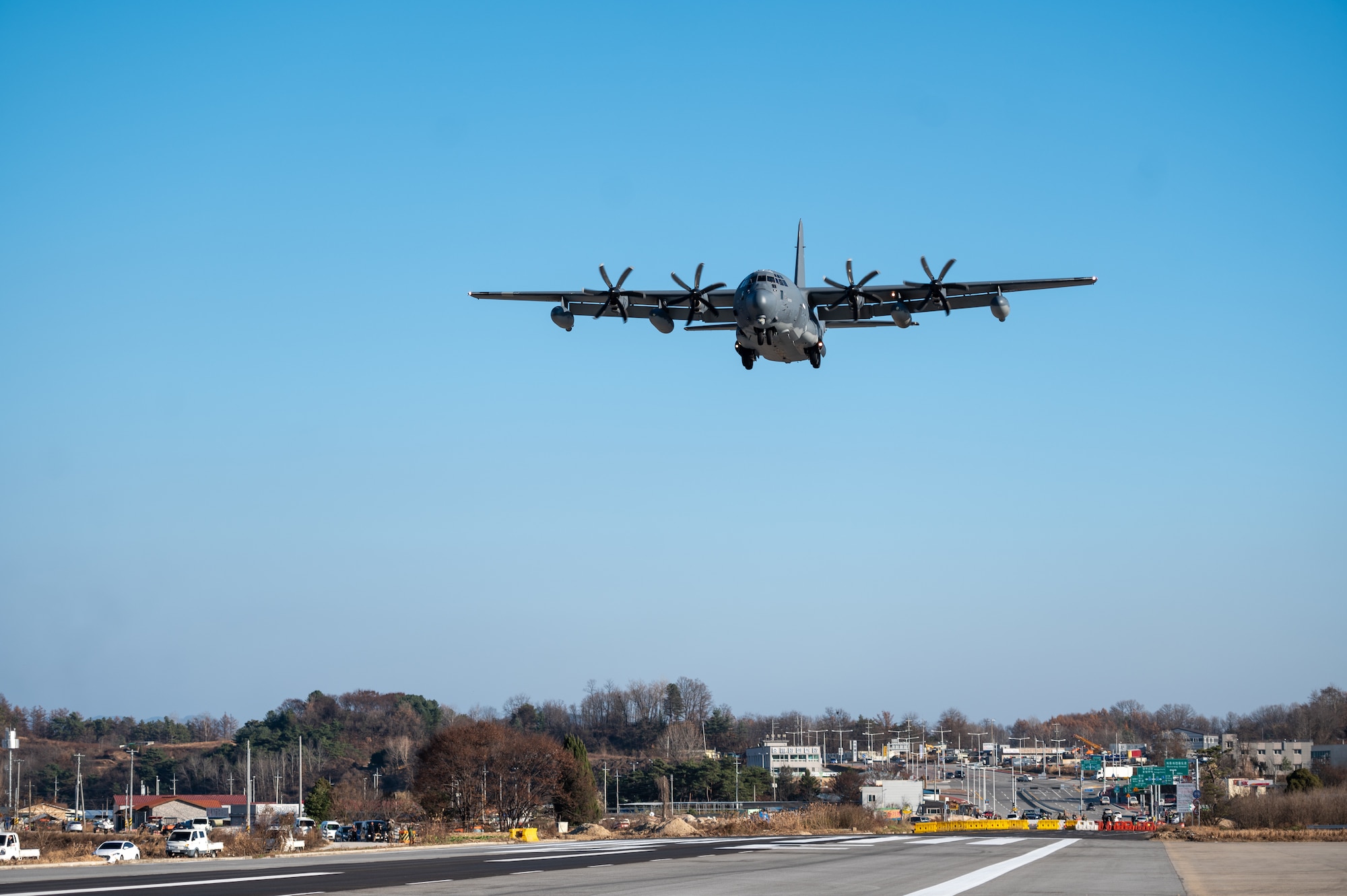 A U.S. Air Force MC-130J Commando II performs a low approach at an emergency landing strip as part of a combined training event involving USAF and Republic of Korea Air Force partners