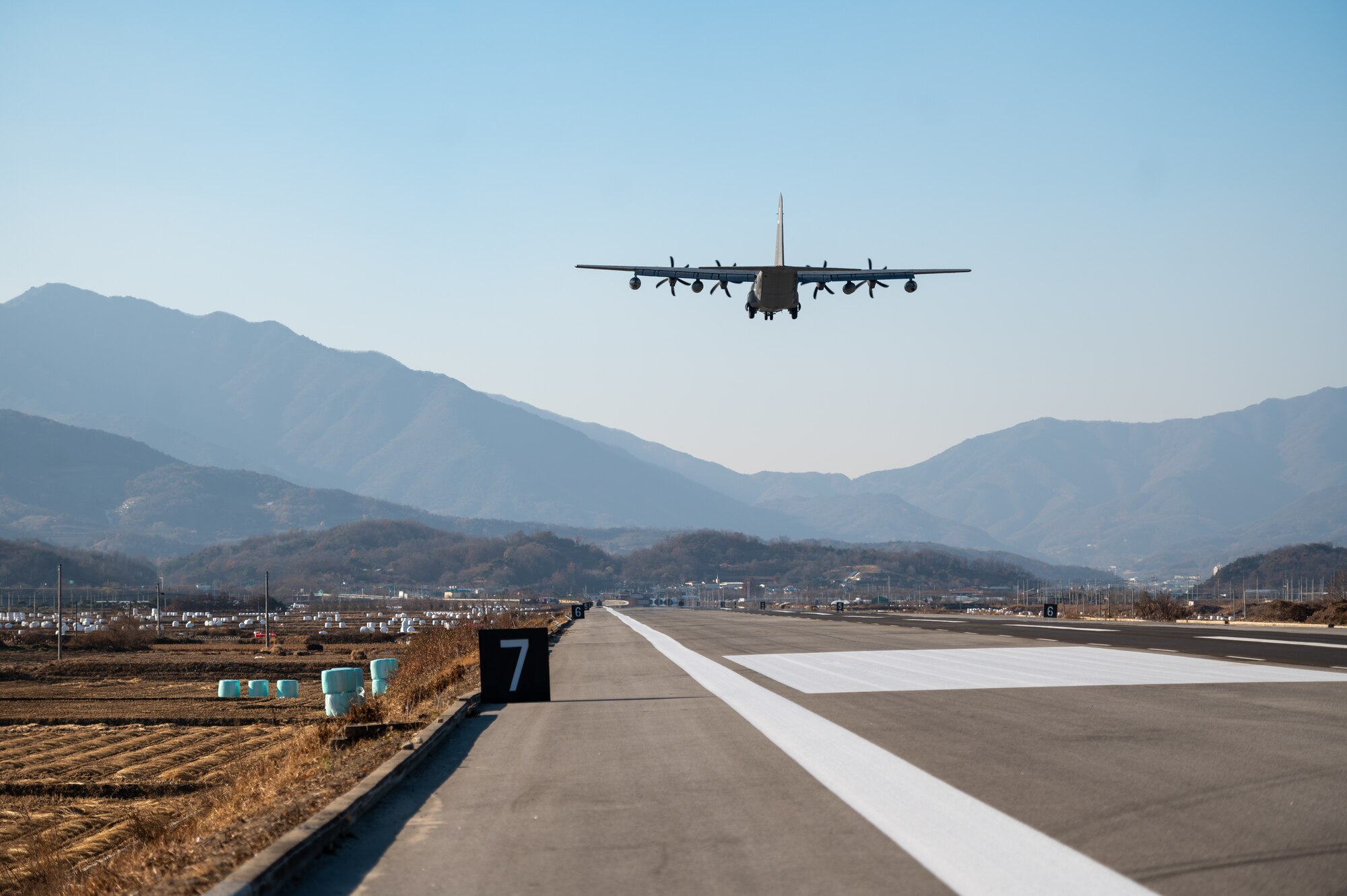A U.S. Air Force MC-130J Commando II takes off after performing a low approach at an emergency landing strip as part of a combined training event involving USAF and Republic of Korea Air Force partners