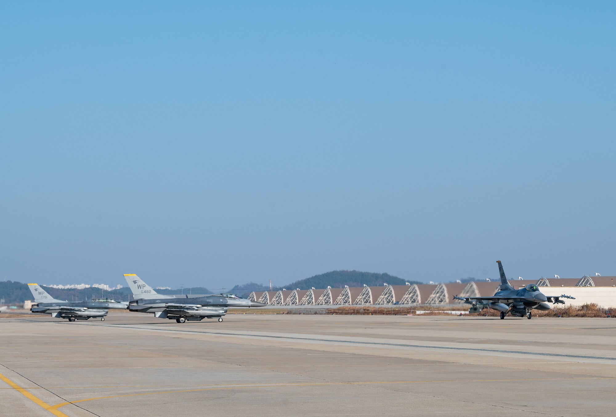Three F-16 Fighting Falcons taxi at Kunsan Air Base, Republic of Korea, Nov. 18, 2022. The Wolf Pack always trains to further improve their combat capabilities in the Indo-Pacific theater, utilizing their unique maneuverability to provide complex threats for adversaries’ fourth and fifth-generation aircraft or surface-to-air missiles. (U.S. Air Force photo by Staff Sgt. Sadie Colbert)