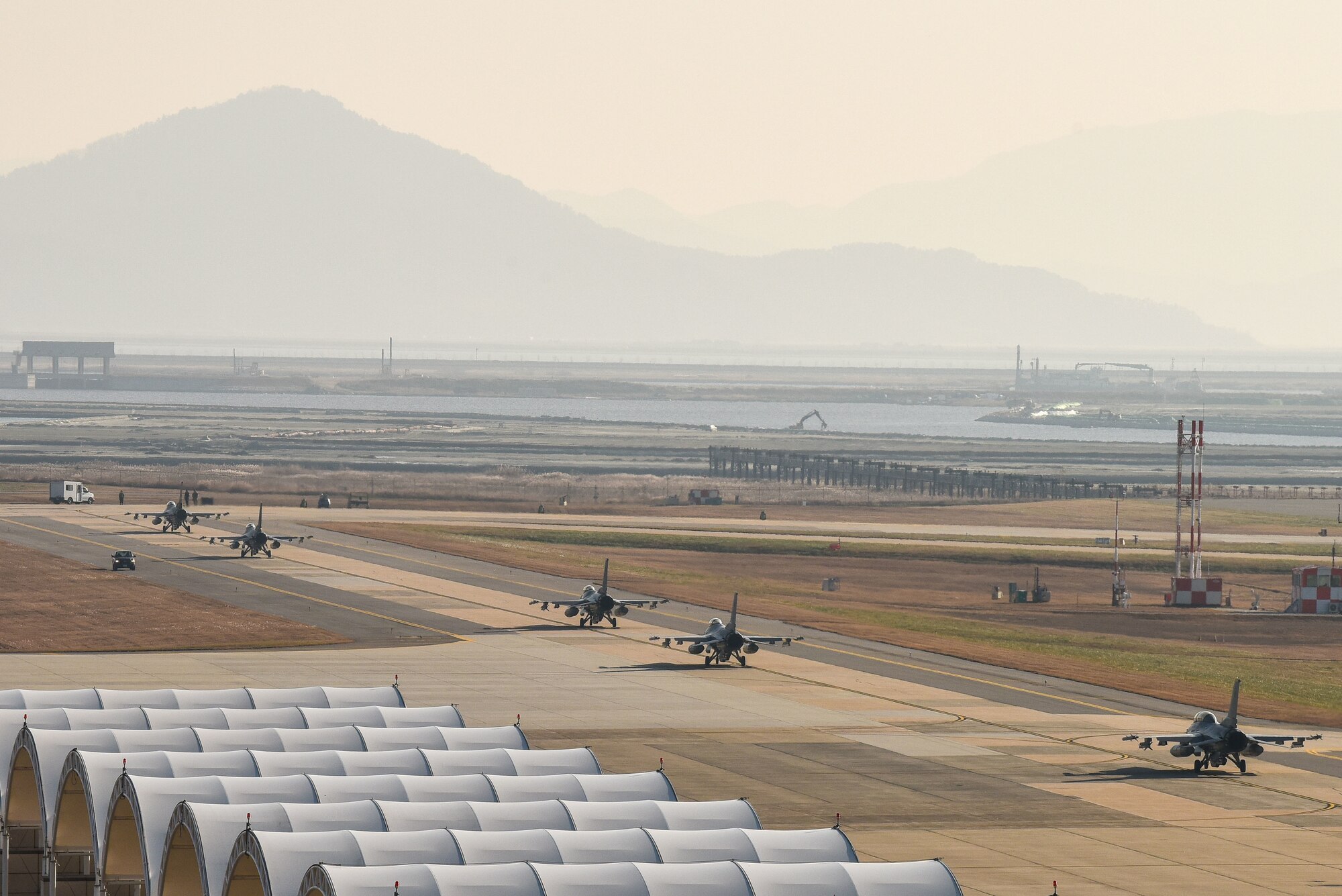 Five F-16 Fighting Falcons assigned to the 80th Fighter Squadron taxi down the flightline at Kunsan Air Base, Republic of Korea, Nov. 18, 2022. The 80th Fighter squadron stands ready to conduct counter-air, air interdiction and close air support missions in support of a free and open indo-pacific region. (U.S. Air Force photo by Tech. Sgt. Timothy Dischinat)