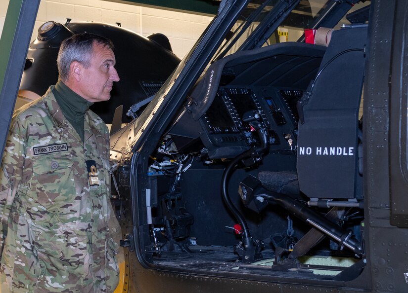 Rear Adm. Frank Trojahn, an attaché from Denmark, examines the cockpit of a UH-60 Blackhawk maintenance training device at the Eastern Army National Guard Aviation Training Site’s Aviation Maintenance Instructional Building here Nov. 16 during Defense Intelligence Agency’s Fall 2022 Operations Orientation Program tour of Pennsylvania National Guard facilities here. (Pennsylvania National Guard photo by Wayne V. Hall)