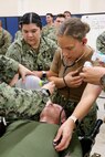 Lt. Cmdr. Barbara J. Berry, an emergency medicine physician, Expeditionary Medical Facility 150-Alpha (EMF150-A), right, and Hospital Corpsman 3rd Class Cianna Robles, EMF 150-A, both out of Camp Pendleton, California, treat a simulated casualty in the EMF at Camp Foster, Marine Corps Base S.D. Butler, Okinawa prefecture, Japan, during exercise Keen Sword 23, Nov. 13. Keen Sword is a joint, bilateral, biennial field-training exercise involving U.S. military and Japan Self-Defense Force personnel, designed to increase combat readiness and interoperability and strengthen the ironclad Japan-U.S. alliance. (Courtesy photo/Released)