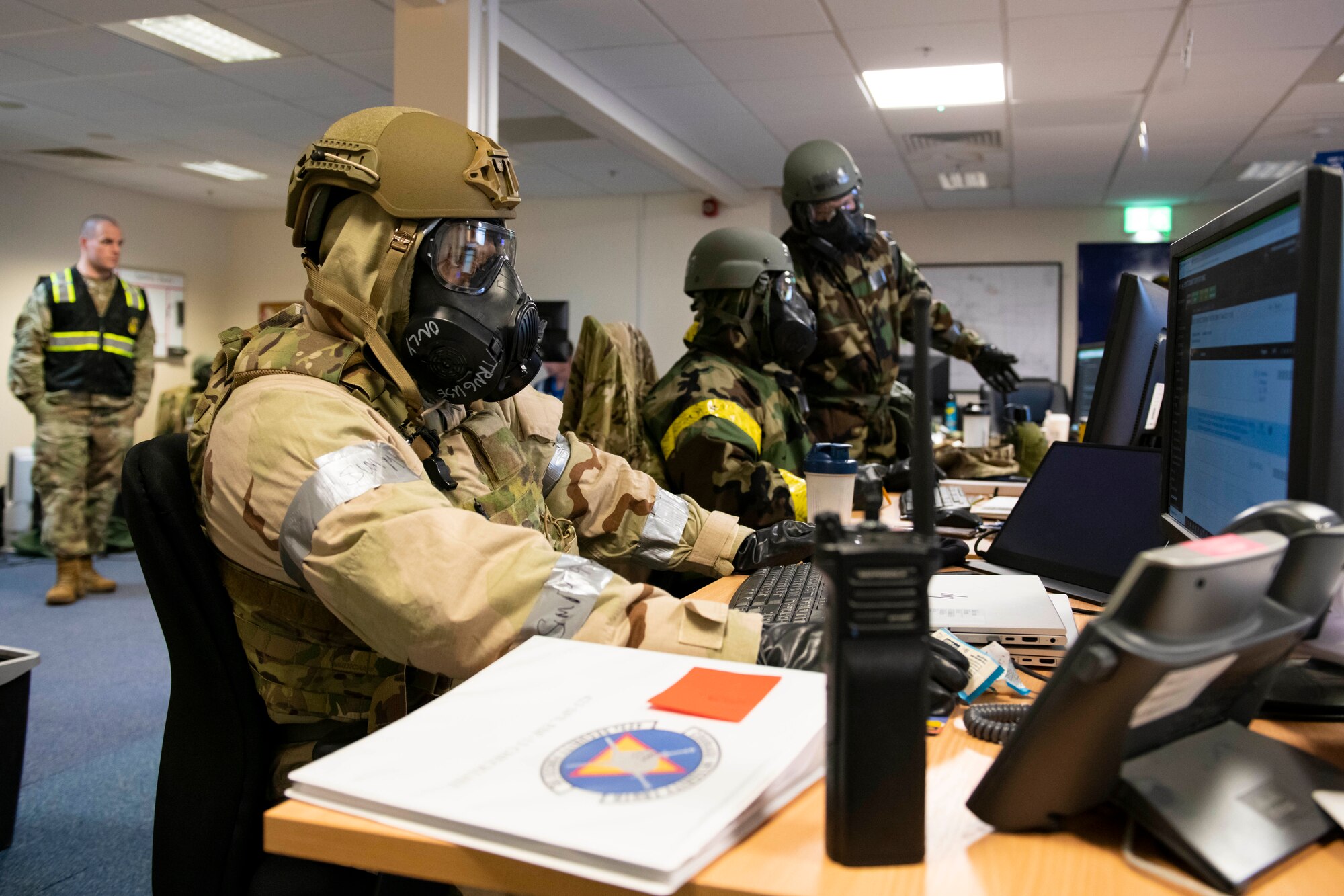 A member of the Emergency Operations Center works during an exercise at RAF Alconbury, England, Nov. 17, 2022. The EOC is the command and control hub for emergency operations on base. Airmen across the 501st Combat Support Wing took part in a readiness exercise to test various capabilities, identify areas for improvement and strengthen operations. (U.S. Air Force photo by Senior Airman Jennifer Zima)