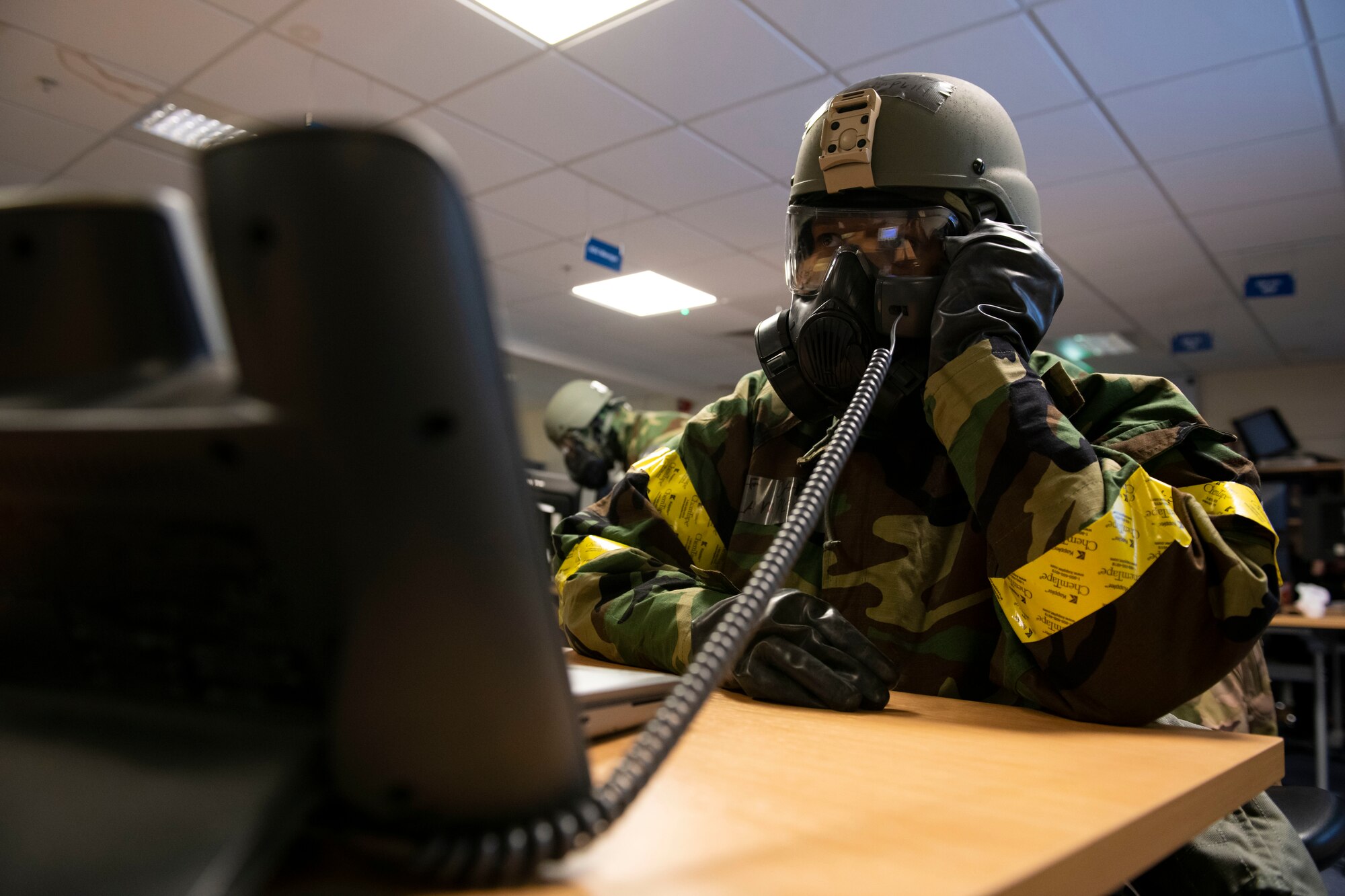 A member of the Emergency Operations Center works during an exercise at RAF Alconbury, England, Nov. 17, 2022. The EOC is the command and control hub for emergency operations on base. Airmen across the 501st Combat Support Wing took part in a readiness exercise to test various capabilities, identify areas for improvement and strengthen operations. (U.S. Air Force photo by Senior Airman Jennifer Zima)