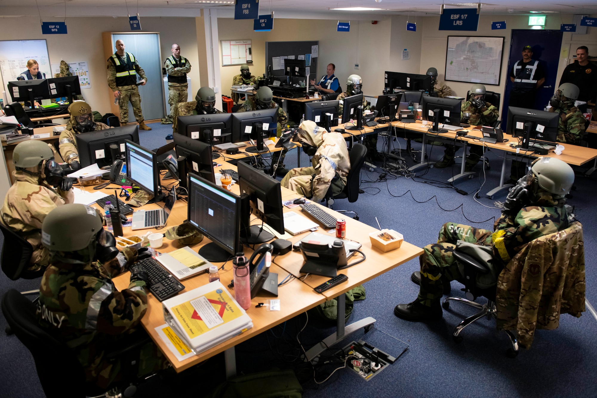 Members of the Emergency Operations Center work together during an exercise at RAF Alconbury, England, Nov. 17, 2022. The EOC is the command and control hub for emergency operations on base. Airmen across the 501st Combat Support Wing took part in a readiness exercise to test various capabilities, identify areas for improvement and strengthen operations. (U.S. Air Force photo by Senior Airman Jennifer Zima)