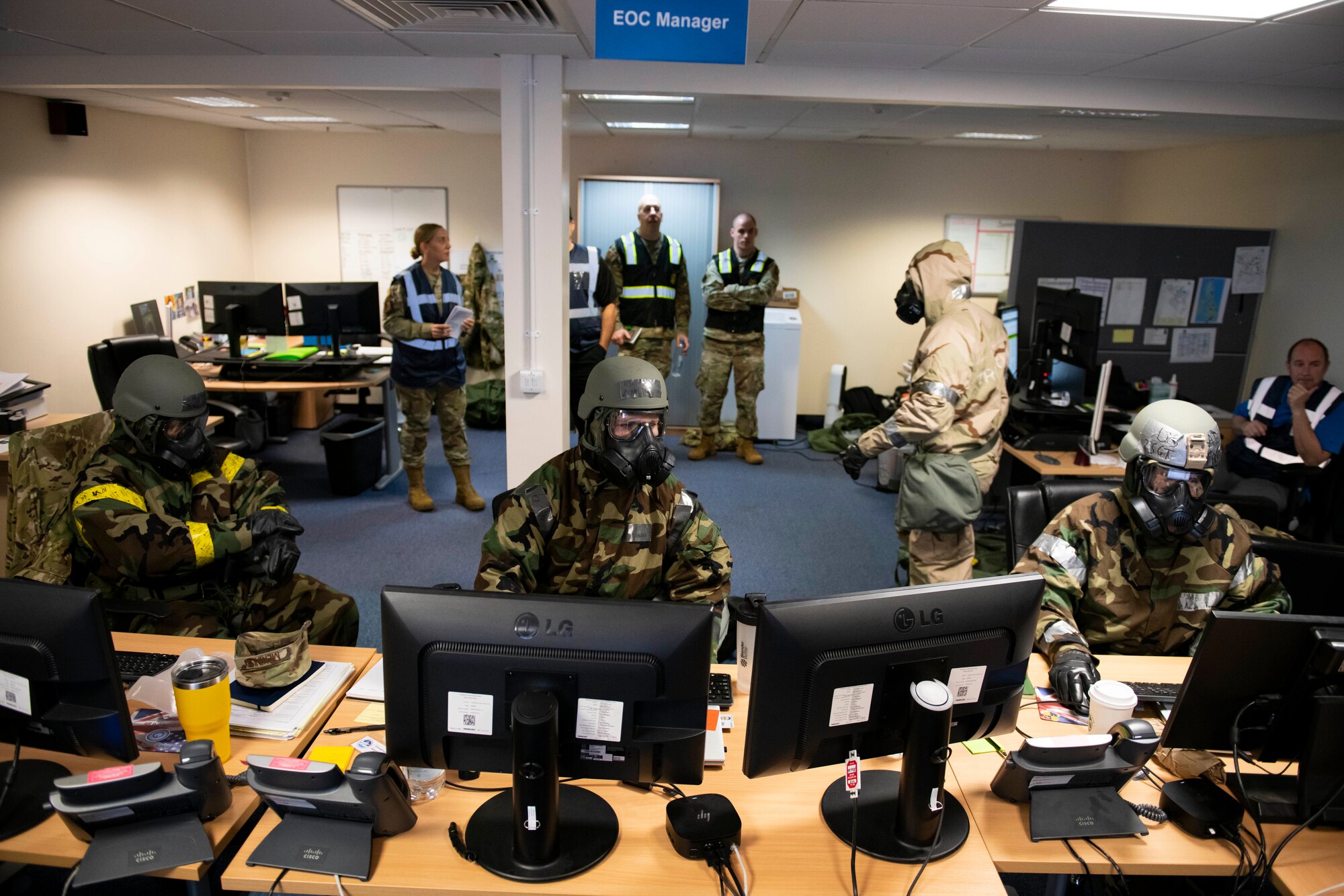 Members of the Emergency Operations Center work together during an exercise at RAF Alconbury, England, Nov. 17, 2022. The EOC is the command and control hub for emergency operations on base. Airmen across the 501st Combat Support Wing took part in a readiness exercise to test various capabilities, identify areas for improvement and strengthen operations. (U.S. Air Force photo by Senior Airman Jennifer Zima)