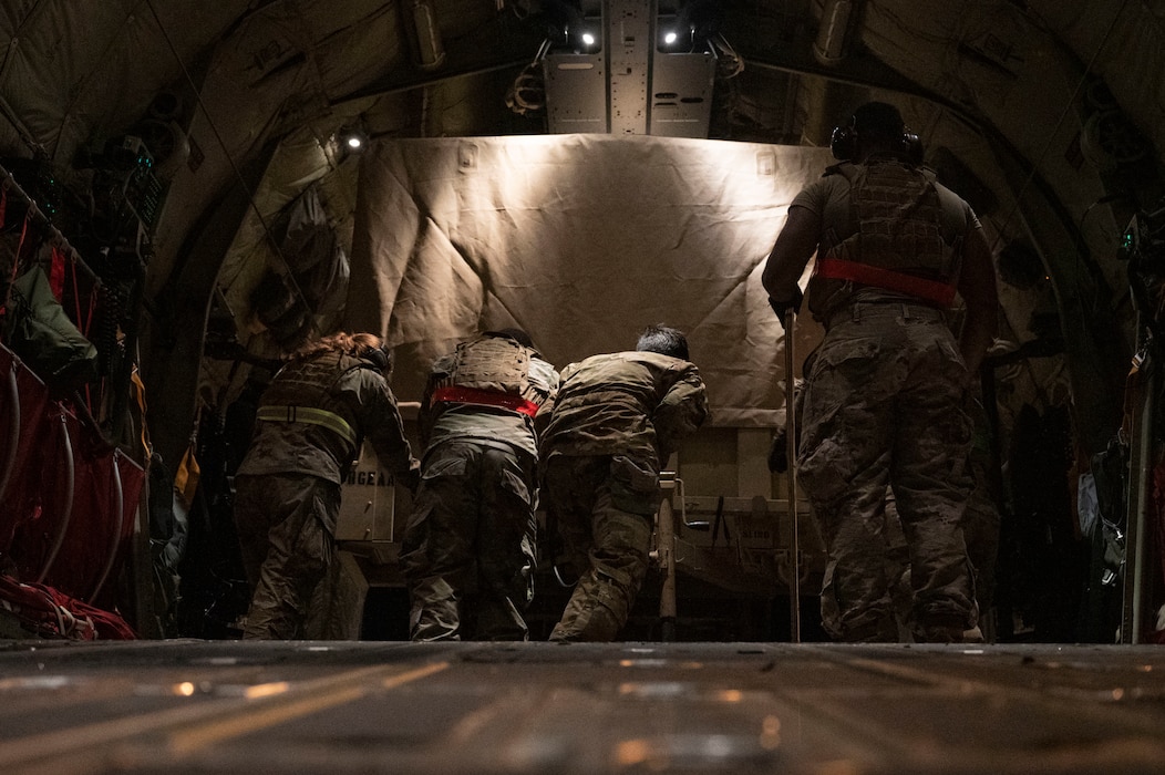 Airmen load cargo onto a C-130J Super Hercules