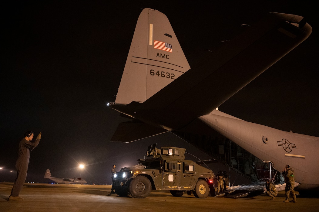 Airmen  load cargo onto a C-130J Super Hercules