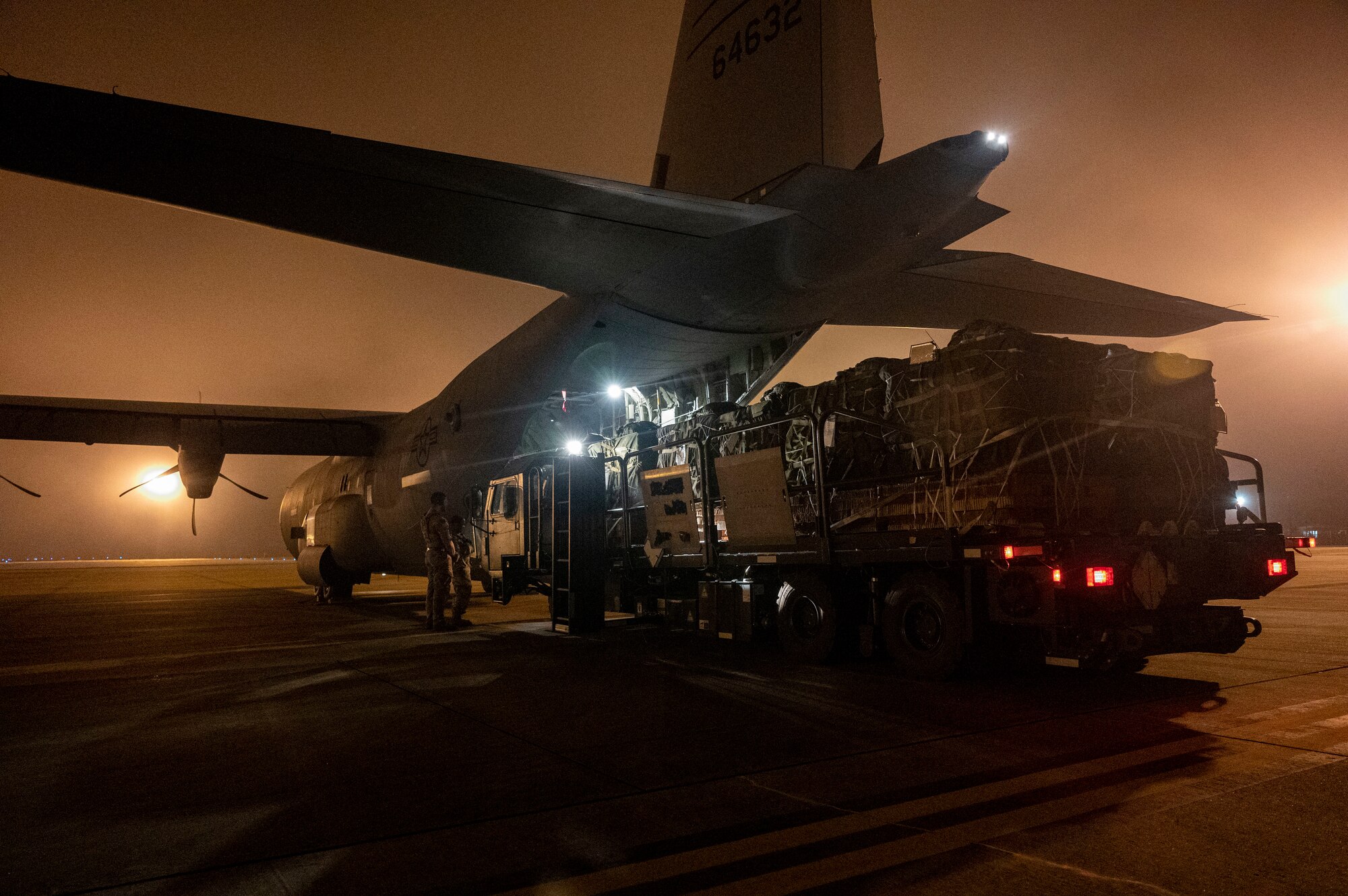 Bundles of cargo are loaded onto a C-130J Super Hercules
