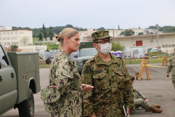 Navy Capt. Elizabeth Smith, commanding officer, Expeditionary Medical Facility 150-Alpha, out of Camp Pendleton, California, along with Lt. Col. Yoshinori Miwa, chief researcher, Medical Service School, Japan Ground Self-Defense Force, observe medical training at Camp Foster, Marine Corps Base S.D. Butler, Okinawa prefecture, Japan, during exercise Keen Sword 23, Nov. 15. Keen Sword is a joint, bilateral, biennial field-training exercise involving U.S. military and Japan Self-Defense Force personnel, designed to increase combat readiness and interoperability and strengthen the ironclad Japan-U.S. alliance. (Courtesy photo/Released)