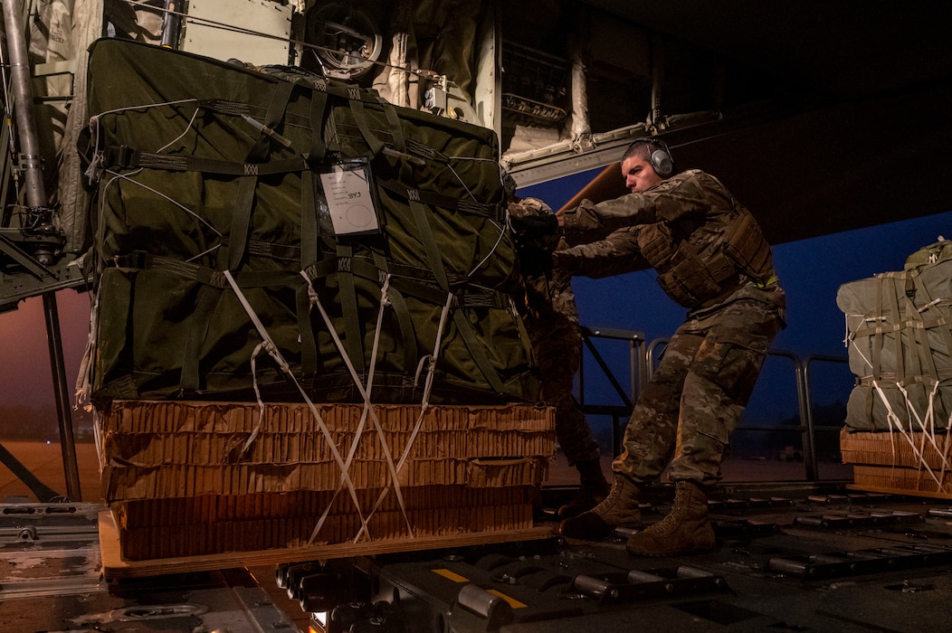 An Airman loads cargo onto a c-130J Super Hercules