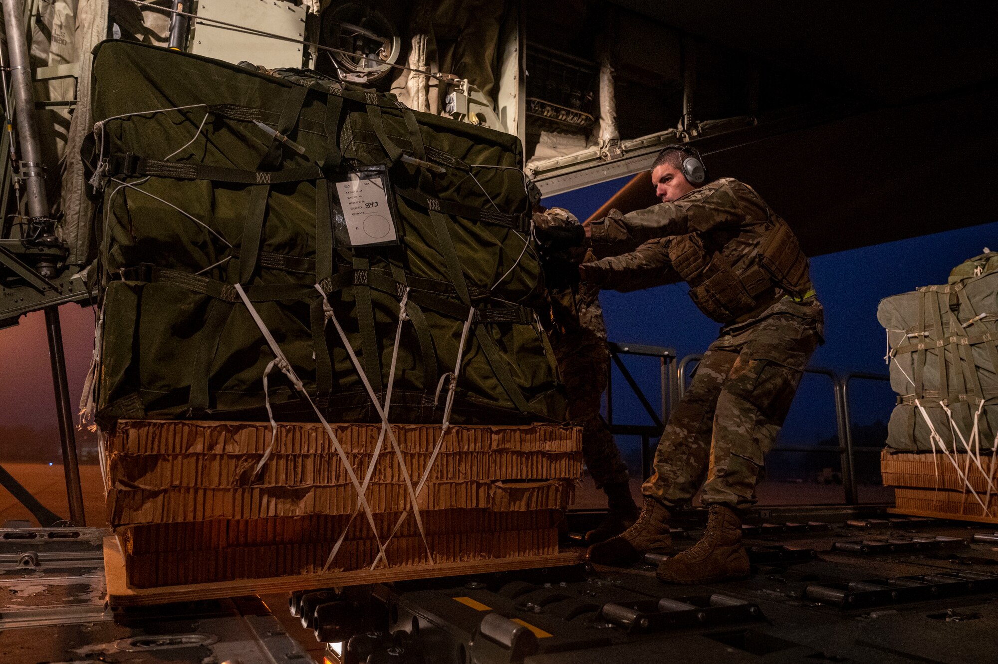 An Airman loads cargo onto a c-130J Super Hercules