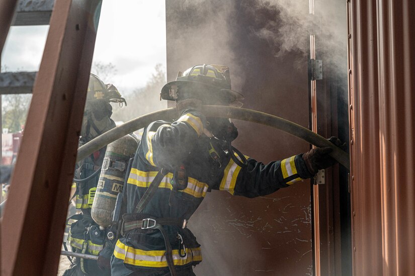 Ray Flora, Hampton Division of Fire and Rescue medic firefighter, enters a building with a “Class A” fire during a rapid intervention team work exercise in the burn building at Joint Base Langley-Eustis, Virginia, Nov. 17, 2022.