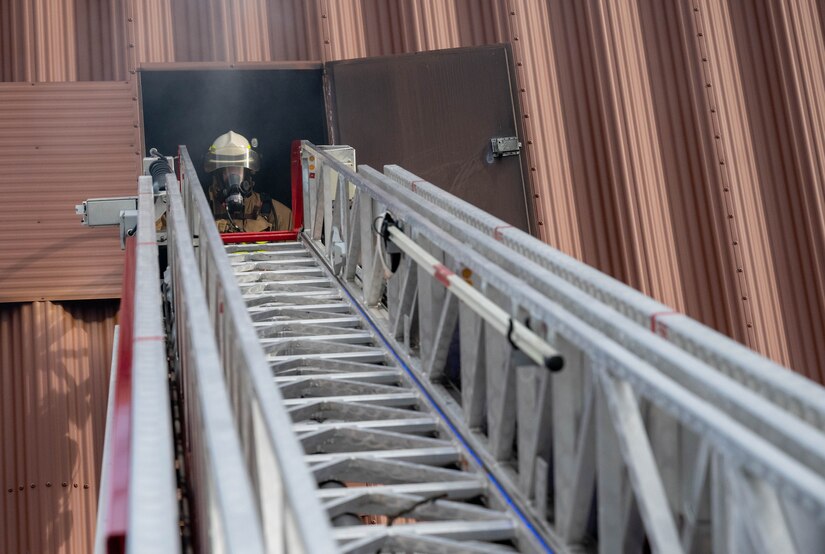 U.S. Air Force Master Sgt. Kyle Nelson, 142d Civil Engineer Squadron Air National Guard firefighter, performs interior safety duties during a rapid intervention team work exercise in the burn building at Joint Base Langley-Eustis, Virginia, Nov. 17, 2022.