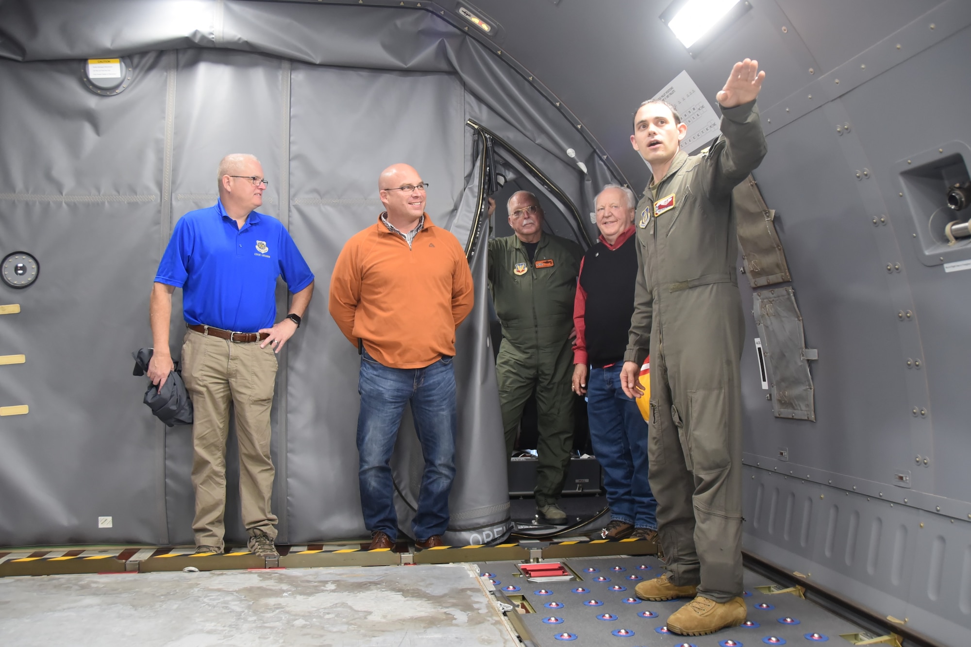 (Left to right) Tech. Sgt. Alex Mark, 924th Air Refueling Squadron boom operator, discusses the cargo hold of the KC-46A Pegasus to 931st Air Refueling Wing civic leaders before a civic leader flight.