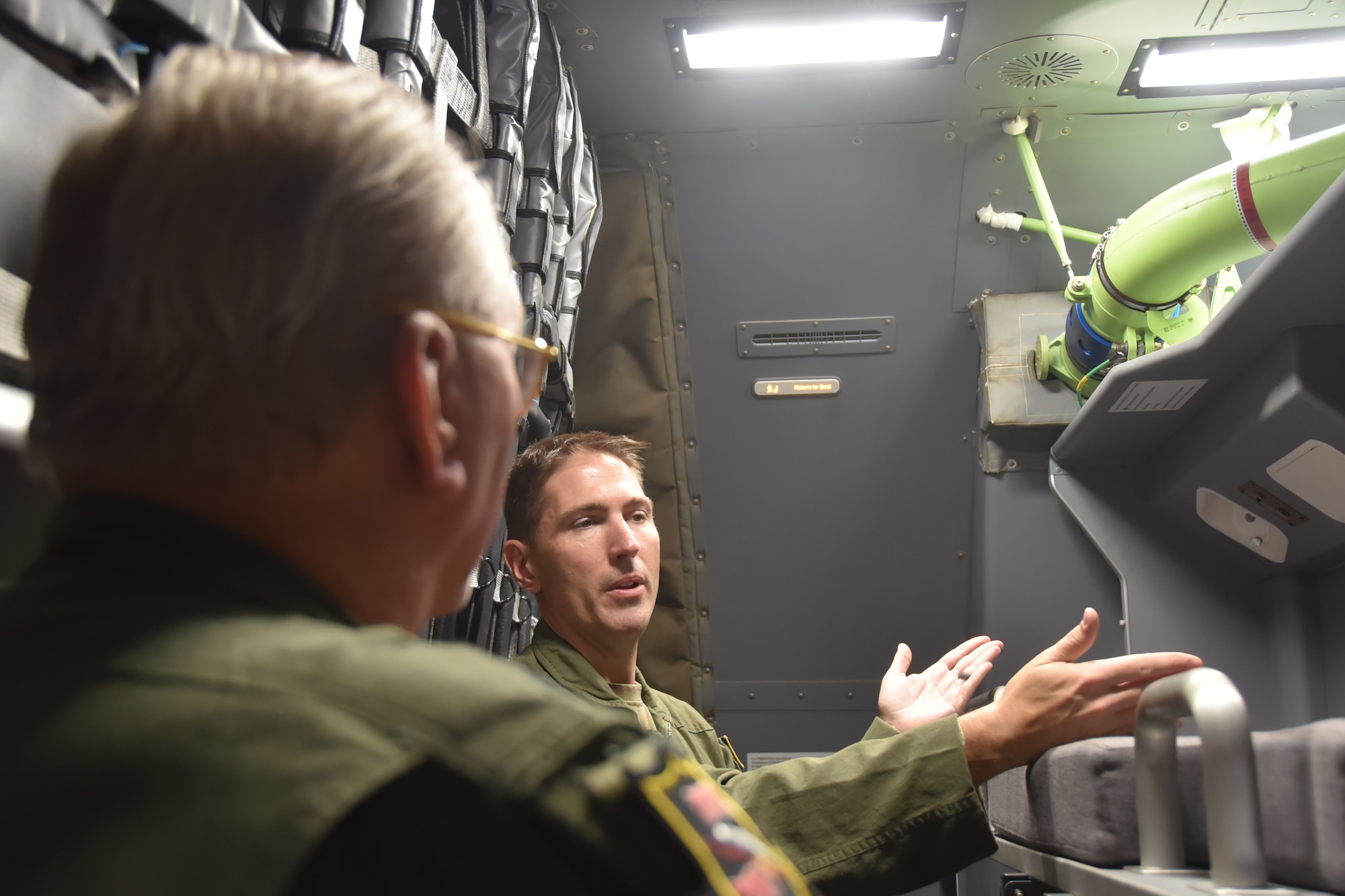 (Right to left) Capt. Matt Tener, 905th Air Refueling Squadron pilot, discusses the sleeping areas of the KC-46A Pegasus to Bill Schwertfeger, 931st Air Refueling Wing civic leader on a KC-46.