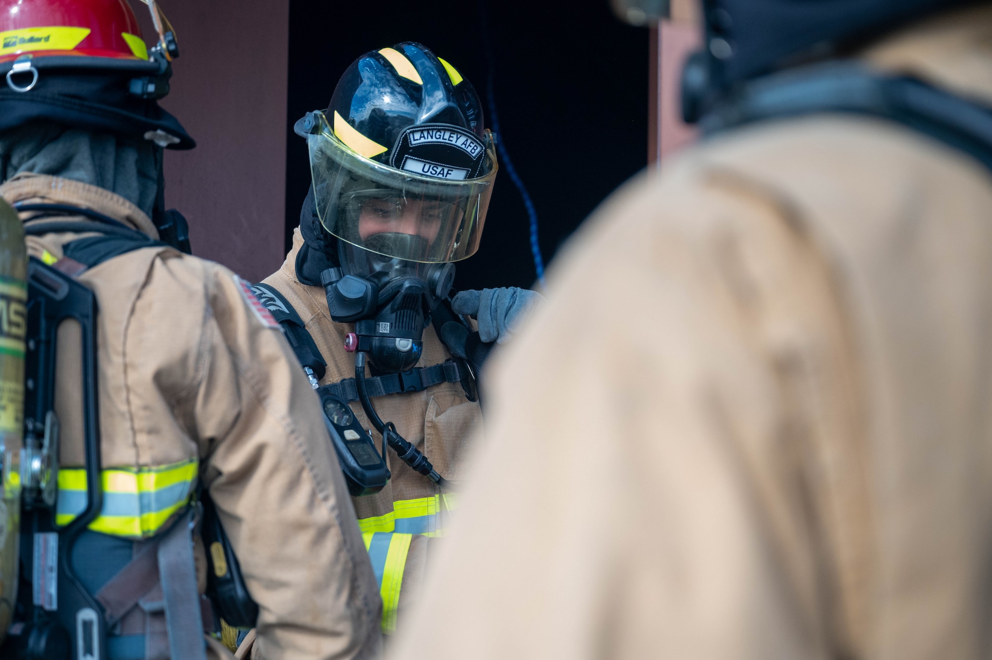 U.S. Air Force Senior Airman Miguel Holloway, 633d Civil Engineer Squadron firefighter, prepares to perform hydraulic ventilation inside the burn building during a rapid intervention team work exercise at Joint Base Langley-Eustis, Virginia, Nov. 17, 2022.