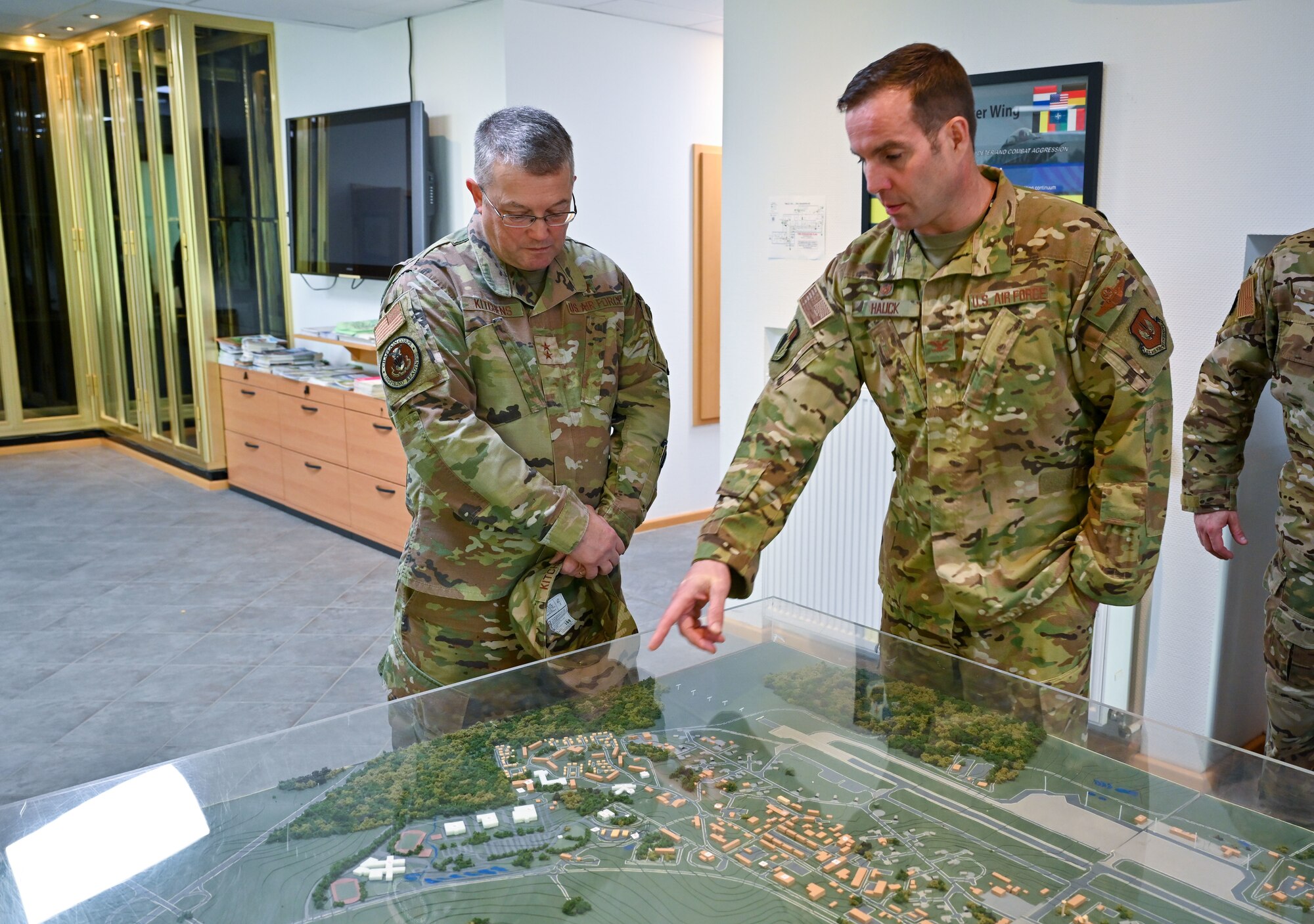 Col. Leslie Hauck, 52nd Fighter Wing commander, (right), shows Chaplain (Maj. Gen.) Randall Kitchens, U.S. Air Force chief of chaplains, a map of the base during a tour at Spangdahlem Air Base, Germany, Nov. 16, 2022. Kitchens visited Spangdahlem to engage with units supporting the NATO defense operations in support of the Ukraine crisis. (U.S. Air Force photo by Senior Airman Jessica Sanchez-Chen)