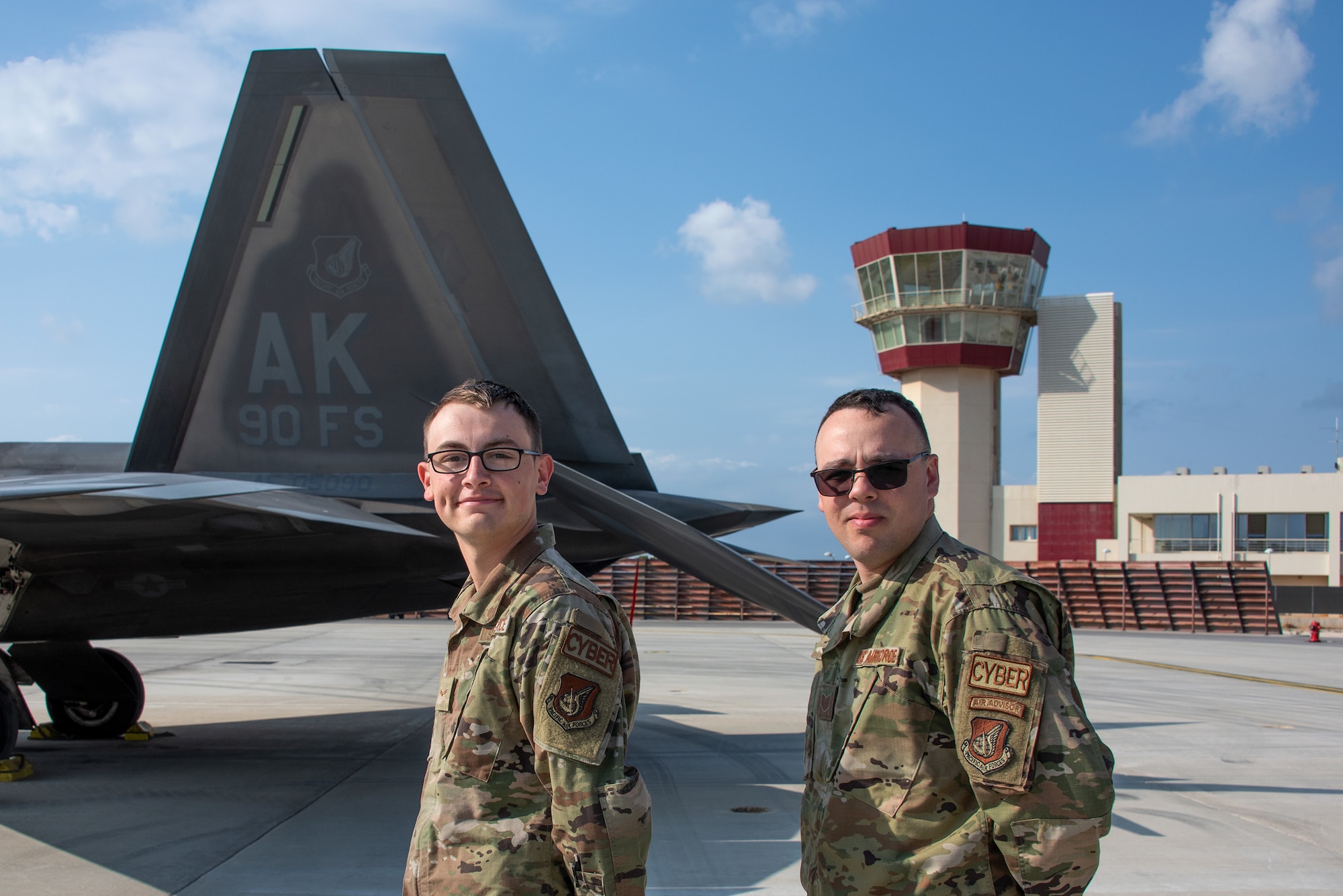 Ethan Koetter and Matthew Vile in front of an F-22