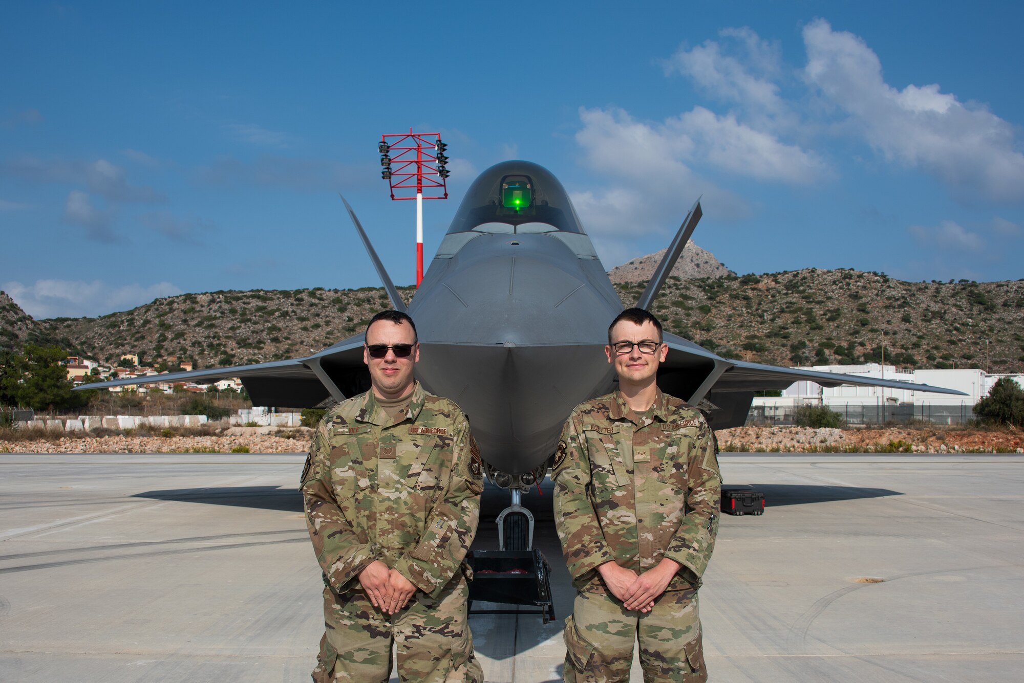 Ethan Koetter and Matthew Vile in front of an F-22
