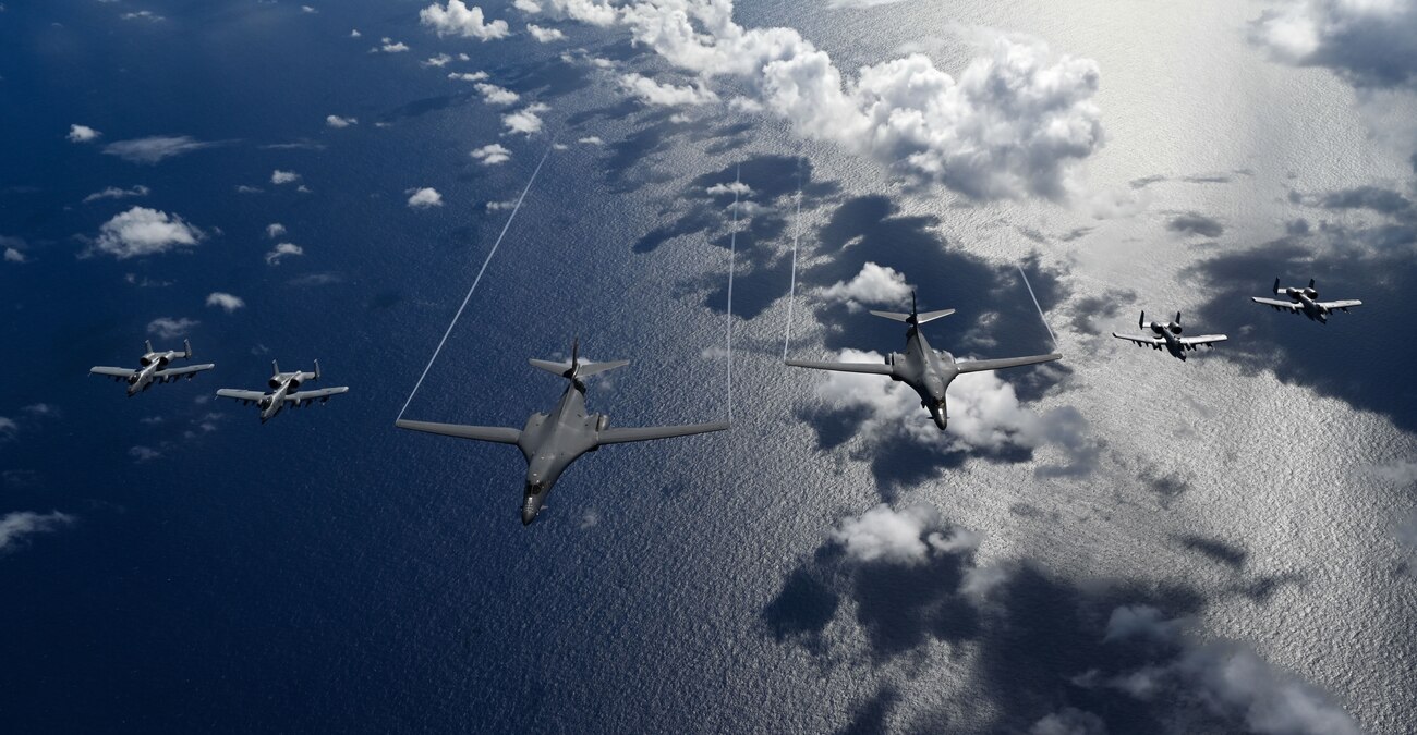 Two U.S. Air Force B-1B Lancers assigned to Ellsworth Air Force Base, S.D., and four U.S. Air Force A-10C Thunderbolt IIs assigned to Moody Air Force Base, Ga., fly in a joint formation during a Bomber Task Force mission over the Pacific Ocean
