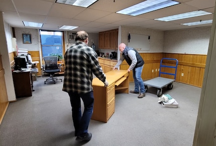 Isaac Newman, right, director of the U.S. Army Medical Materiel Agency’s Medical Maintenance Operations Division in Tracy, California, assists with moving a desk and office equipment as part of the division’s move to a different, more modern building at Tracy Defense Distribution Depot. Also pictured is Cameron Campbell, a lead for MMOD-Tracy’s Forward Repair Activity-Medical team.