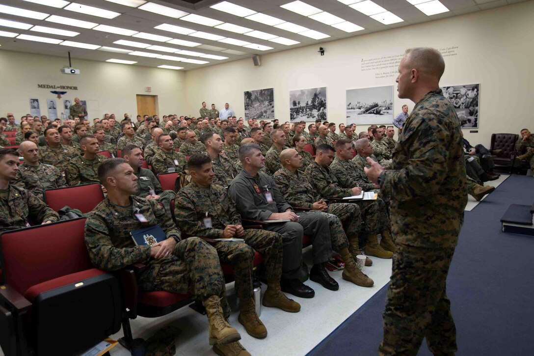 U.S. Marine Corps Maj. Daniel Crain, an infantry officer with Expeditionary Warfare Training Group, Atlantic, explains the intent of the upcoming exercise during an Amphibious Ready Group and Marine Expeditionary Unit Staff Planning Course (AMSPC) at Joint Expeditionary Base Little Creek, Virginia, Nov. 14, 2022. This course provides the opportunity for the Marines and Sailors to integrate, plan and think like a team as they prepare for future deployments. AMSPC enhances staff integration, planning and preparation for follow on training and subsequent deployments. (U.S. Marine Corps illustration by Lance Cpl. Jack Chen)