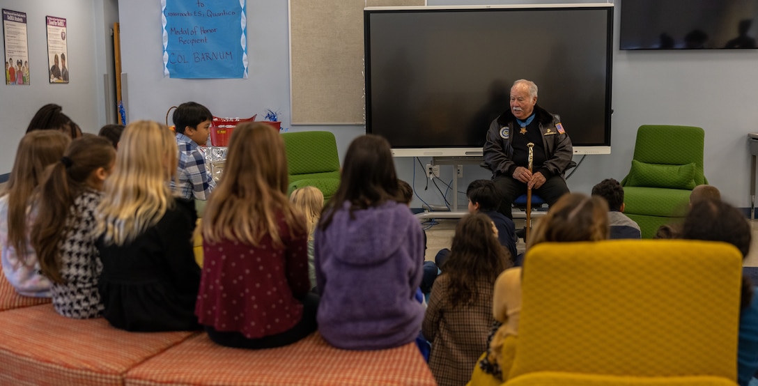 Retired U.S. Marine Corps Col. Harvey Barnum, a native of Cheshire, Connecticut, speaks to a fourth grade class at the Crossroads Elementary School, Marine Corps Base Quantico, Virginia, Nov. 15, 2022. Barnum, a Medal of Honor recipient spoke to the students about the importance of courage, integrity, and commitment. Students have gathered, interpreted, and used evidence to research recipients of the Medal of Honor in order to explain how the recipient exemplified the values of the recognition. Barnum was the fourth Marine to earn the Medal of Honor for taking control of his unit under heavy enemy fire, and saving the lives of his Marines and Sailors during the Vietnam War. (U.S. Marine Corps photo by Lance Cpl. Jeffery Stevens)