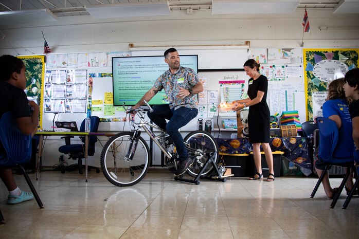 The Energy-Utility Branch at Marine Corps Base Hawaii conducts an experiment during an energy presentation at Mokapu Elementary School, MCBH, Nov. 10, 2022. The purpose of the presentation was to inform students on where energy comes from, energy conservation and the importance of protecting resources.