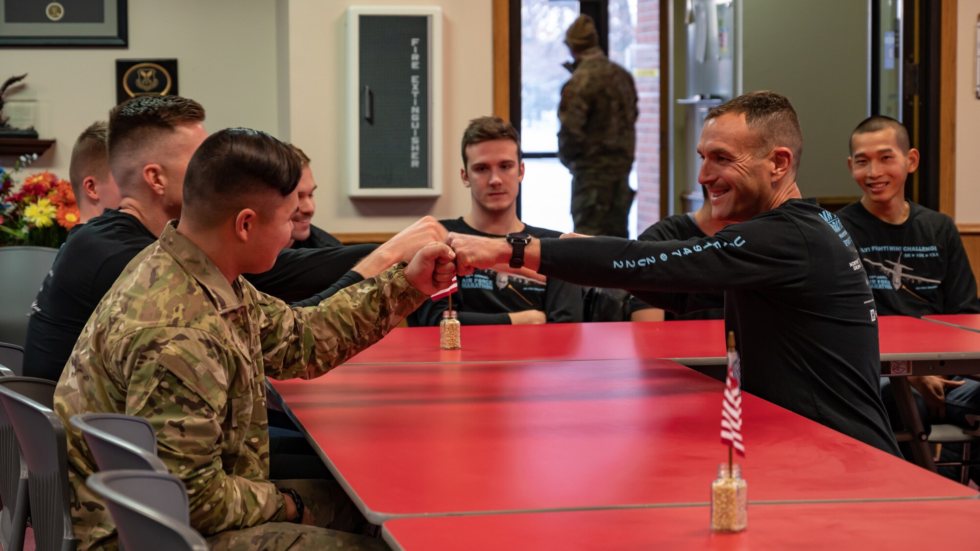 Airmen celebrate during the presentation of an Air Force Marathon Medal at Minot Air Force, North Dakota, Nov. 15, 2022.  The Airmen participated in the Bismarck Marathon as a substitution to the Air Force Marathon held on Sept. 17, 2022, which was at Wright-Patterson Air Force Base, Ohio.  (U.S. Air Force Photo by Airman 1st Class Alexander Nottingham)