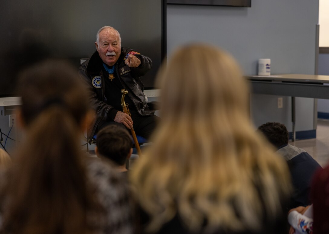Retired U.S. Marine Corps Col. Harvey Barnum, a native of Cheshire, Connecticut, speaks to a fourth grade class at the Crossroads Elementary School, Marine Corps Base Quantico, Virginia, Nov. 15, 2022. Barnum, a Medal of Honor recipient spoke to the students about the importance of courage, integrity, and commitment. Students have gathered, interpreted, and used evidence to research recipients of the Medal of Honor in order to explain how the recipient exemplified the values of the recognition. Barnum was the fourth Marine to earn the Medal of Honor for taking control of his unit under heavy enemy fire, and saving the lives of his Marines and Sailors during the Vietnam War. (U.S. Marine Corps photo by Lance Cpl. Jeffery Stevens)