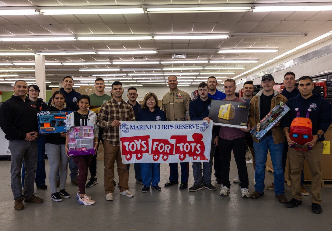 U.S. Marine volunteers from Marine Corps Base Quantico and 4th Light Armored Reconnaissance Battalion, 4th Marine Division, Marine Forces Reserve, pose for a group photo with civilian volunteers during a Toys for Tots event in Fredericksburg, Virginia, Nov. 16, 2022. Toys for Tots is a program founded in 1947 by the Marine Corps Reserve which distributes toys to children whose parents cannot afford presents during the Christmas Season. (U.S. Marine Corps photo by Lance Cpl. Joaquin Dela Torre)