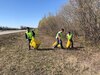 Staff Sgt. Austin L. Cardines, Senior Airman Alexander Cole Baham and Senior Airman John Aquino III of the 168th Logistics Readiness Squadron pick up trash in support of the Top 3 Highway Clean-up of Mile marker 353 to 354. The 168th Wing Top 3 Organization adopted a section on the Richardson Highway miles down from the base and close to the community the wing lives and plays in with their families. (Courtesy Photo)