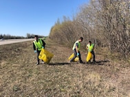 Staff Sgt. Austin L. Cardines, Senior Airman Alexander Cole Baham and Senior Airman John Aquino III of the 168th Logistics Readiness Squadron pick up trash in support of the Top 3 Highway Clean-up of Mile marker 353 to 354. The 168th Wing Top 3 Organization adopted a section on the Richardson Highway miles down from the base and close to the community the wing lives and plays in with their families. (Courtesy Photo)