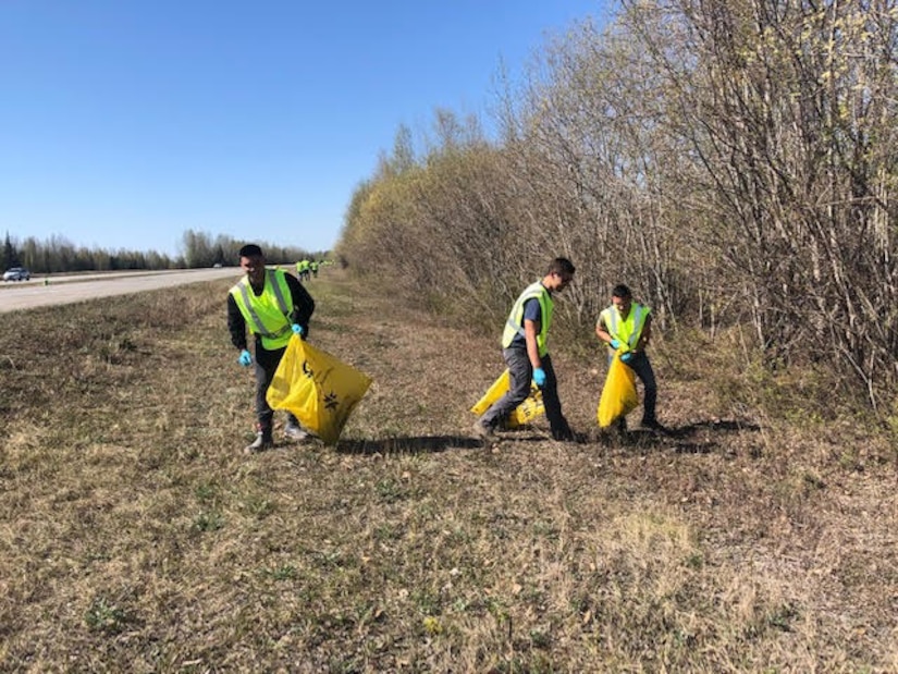 Staff Sgt. Austin L. Cardines, Senior Airman Alexander Cole Baham and Senior Airman John Aquino III of the 168th Logistics Readiness Squadron pick up trash in support of the Top 3 Highway Clean-up of Mile marker 353 to 354. The 168th Wing Top 3 Organization adopted a section on the Richardson Highway miles down from the base and close to the community the wing lives and plays in with their families. (Courtesy Photo)