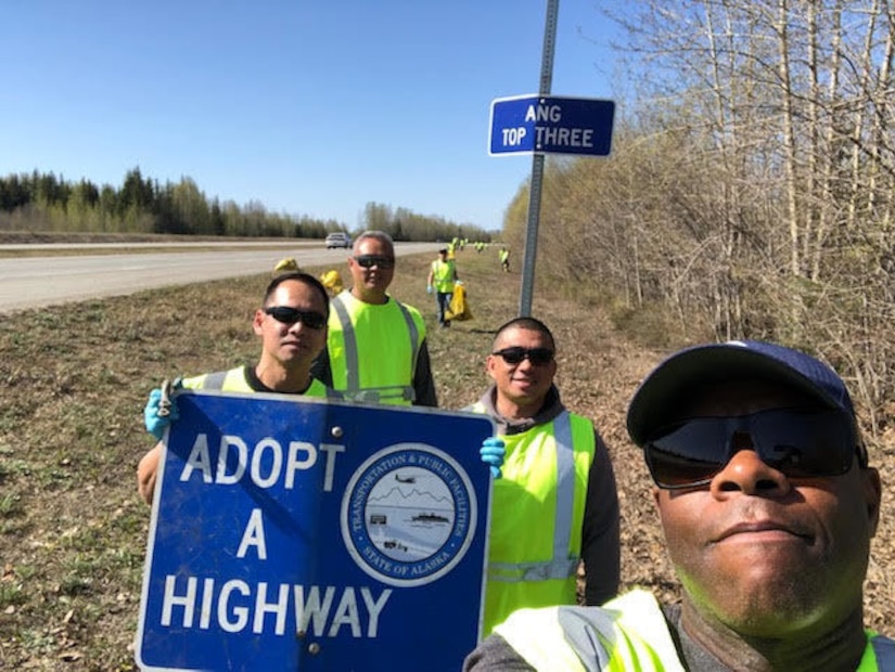 Senior Master Sgt. Ruperto Perez III, Master Sgt. Albert Atoigue, Master Sgt. Shane Jenkins, Master Sgt. RJ Cardines and Senior Airman Kyle Wilson (in the background) of the 168th Wing take a photo op during the Top 3 Highway Clean-up of Mile marker 353 to 354 between North Pole and Fairbanks, Alaska. The Airmen fix the sign while cleaning up the roadside. The 168th Wing Top 3 Organization adopted a section on the Richardson Highway miles down from the base and close to the community the wing lives and plays in with their families. (Courtesy Photo)